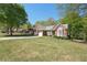 Sprawling front yard showcasing a brick home with a two-car garage and manicured landscaping at 1670 Bookhout Dr, Cumming, GA 30041