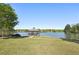 Picturesque gazebo overlooking a tranquil lake surrounded by lush greenery, creating a peaceful retreat at 1670 Bookhout Dr, Cumming, GA 30041