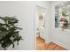Hallway view showcases hardwood flooring, a powder room, and a built-in display cabinet at 1670 Bookhout Dr, Cumming, GA 30041