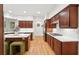 Modern kitchen boasts dark wood cabinets, white countertops, a central island, and seating at 1670 Bookhout Dr, Cumming, GA 30041