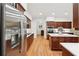 Gourmet kitchen featuring stainless steel appliances, light countertops, and wood floors at 1670 Bookhout Dr, Cumming, GA 30041