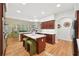 Spacious kitchen featuring a central island, dark wood cabinets, and an open view into the living area at 1670 Bookhout Dr, Cumming, GA 30041