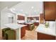 Bright, open kitchen with wood cabinets, white countertops, and a kitchen island at 1670 Bookhout Dr, Cumming, GA 30041