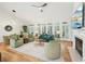 Bright living room featuring a fireplace, built-in shelving, and large windows overlooking the yard at 1670 Bookhout Dr, Cumming, GA 30041