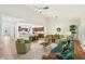 Inviting living room with a modern fan, stylish furniture, and an open connection to the kitchen at 1670 Bookhout Dr, Cumming, GA 30041