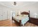 Elegant main bedroom with hardwood floors, a decorative bed frame, and many windows at 1670 Bookhout Dr, Cumming, GA 30041
