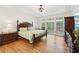 Spacious main bedroom with hardwood floors, tray ceiling, and many windows at 1670 Bookhout Dr, Cumming, GA 30041