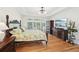 Comfortable main bedroom with hardwood floors, a TV, and multiple windows at 1670 Bookhout Dr, Cumming, GA 30041