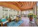 Inviting screened-in porch with comfortable seating, ceiling fan, and a view of the outdoors at 1670 Bookhout Dr, Cumming, GA 30041