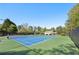 Bright community tennis courts surrounded by trees, offering ample space for sports and recreation at 1670 Bookhout Dr, Cumming, GA 30041