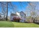Exterior view of the backyard with a house and a deck at 2317 Rocksram Ct, Buford, GA 30519
