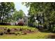 Backyard exterior view of the house with deck and trees at 2317 Rocksram Ct, Buford, GA 30519