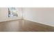 Bedroom featuring hardwood floors and a large window at 2317 Rocksram Ct, Buford, GA 30519