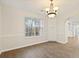 Dining room features hardwood floors, a chandelier, and a large window at 2317 Rocksram Ct, Buford, GA 30519