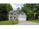 Charming two-story home with stone accents, gray siding, well-manicured lawn and a two car garage at 2317 Rocksram Ct, Buford, GA 30519