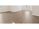 Large living room with hardwood vinyl flooring, lots of sunlight, and a clean aesthetic at 2317 Rocksram Ct, Buford, GA 30519