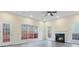 Spacious living room with a fireplace, large windows and modern light fixtures at 2317 Rocksram Ct, Buford, GA 30519