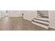 Spacious living area with hardwood floors, neutral paint, and access to staircase at 2317 Rocksram Ct, Buford, GA 30519