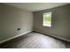 This bedroom features modern flooring and a sun-filled window at 820 Emerald Forest Cir, Lawrenceville, GA 30044