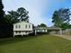 Charming two-story home featuring a spacious front lawn, and a convenient carport at 820 Emerald Forest Cir, Lawrenceville, GA 30044