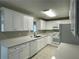 Modern kitchen featuring white cabinets, stylish countertops, and stainless-steel appliances at 820 Emerald Forest Cir, Lawrenceville, GA 30044