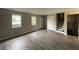 Bright living room with wood-look flooring, natural light, and easy access to the staircase at 820 Emerald Forest Cir, Lawrenceville, GA 30044