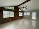 Bright living room featuring a high ceiling, exposed beams, and large windows for plenty of natural light at 820 Emerald Forest Cir, Lawrenceville, GA 30044