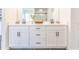 Bright bathroom features double vanity with white cabinets and black hardware at 1715 Fulmont Cir, Mableton, GA 30126