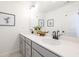 Bright bathroom with double sinks, a large mirror, white countertops, and stylish black hardware and light fixture at 1715 Fulmont Cir, Mableton, GA 30126