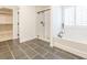Bright bathroom features glass shower, soaking tub, and tiled floors at 1715 Fulmont Cir, Mableton, GA 30126