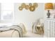 Well-lit bedroom featuring a comfy bed with decorative pillows, a dresser with decor, and neutral walls at 1715 Fulmont Cir, Mableton, GA 30126