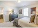 Cozy bedroom featuring a dresser with a mirror, neutral walls and carpet, and natural light from a window at 1715 Fulmont Cir, Mableton, GA 30126