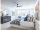Bright bedroom features a ceiling fan, soft lighting, and plenty of natural light at 1715 Fulmont Cir, Mableton, GA 30126