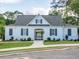 Exterior view of a community clubhouse with white brick, a covered entryway, and manicured landscaping at 1715 Fulmont Cir, Mableton, GA 30126