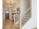 Elegant home entryway with wood floors, decorative lighting, and a staircase with metal spindles at 1715 Fulmont Cir, Mableton, GA 30126