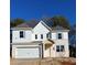 Beautiful two-story home showcasing a brick facade, modern white trim, and a two-car garage at 1715 Fulmont Cir, Mableton, GA 30126