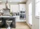 Modern kitchen with white cabinets, stainless steel appliances, and views to the home's entry door at 1715 Fulmont Cir, Mableton, GA 30126