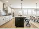Bright kitchen featuring white cabinets, stainless appliances, a black island, and open access to the dining and living spaces at 1715 Fulmont Cir, Mableton, GA 30126