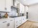 Modern kitchen featuring white cabinets, stainless steel appliances, and light wood floors at 1715 Fulmont Cir, Mableton, GA 30126