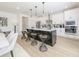 Modern kitchen with white cabinets, stainless appliances, and a black kitchen island with barstool seating at 1715 Fulmont Cir, Mableton, GA 30126
