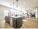 Open concept floor plan with kitchen island, stainless steel dishwasher, and views into the living room at 1715 Fulmont Cir, Mableton, GA 30126