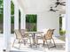 Outdoor patio with a table and chairs next to ceiling fans at 1715 Fulmont Cir, Mableton, GA 30126