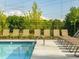 Community pool lined with comfortable lounge chairs for residents to enjoy at 1715 Fulmont Cir, Mableton, GA 30126