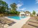 Community pool surrounded by lounge chairs and a pool house offering a relaxing outdoor space at 1715 Fulmont Cir, Mableton, GA 30126