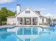 Stunning white pool house reflecting in the crystal-clear pool at 1715 Fulmont Cir, Mableton, GA 30126