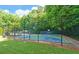 Community basketball court with multiple hoops, benches and picnic tables, enclosed by a black chain link fence at 1871 Birch Briar Bnd, Lawrenceville, GA 30043