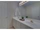 Bright bathroom featuring double sinks, vanity with cabinetry, tile flooring, and large mirror at 1871 Birch Briar Bnd, Lawrenceville, GA 30043