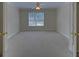 Spacious bedroom with a ceiling fan, neutral carpet, and window at 1871 Birch Briar Bnd, Lawrenceville, GA 30043