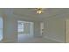 Spacious bedroom with a tray ceiling, ceiling fan, neutral carpet, and doorway to an adjoining room at 1871 Birch Briar Bnd, Lawrenceville, GA 30043