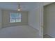 Spacious bedroom with a ceiling fan, neutral carpet, window, and walk-in closet at 1871 Birch Briar Bnd, Lawrenceville, GA 30043